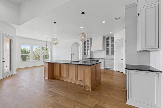 7103 Heathington Ct, Granbury, TX 76049 - kitchen featuring a sink, dark countertops, visible vents, and wood finished floors