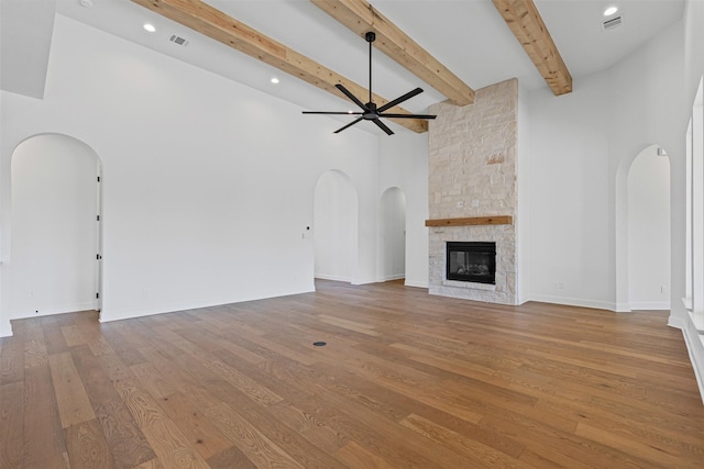 7103 Heathington Ct, Granbury, TX 76049 - unfurnished living room featuring arched walkways, ceiling fan, and visible vents