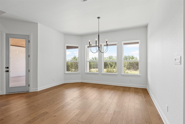 7103 Heathington Ct, Granbury, TX 76049 - unfurnished dining area with a chandelier, baseboards, light wood-type flooring, and a healthy amount of sunlight