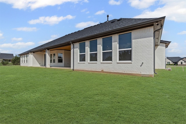 7103 Heathington Ct, Granbury, TX 76049 - rear view of property with a yard, roof with shingles, and brick siding