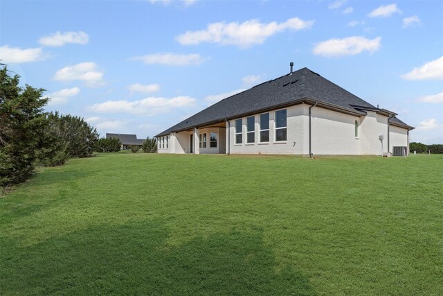 7103 Heathington Ct, Granbury, TX 76049 - back of property with a yard, a shingled roof, central AC unit, and brick siding