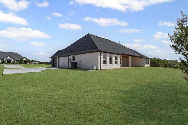 7103 Heathington Ct, Granbury, TX 76049 - back of property featuring central air condition unit, driveway, a garage, a lawn, and a shingled roof