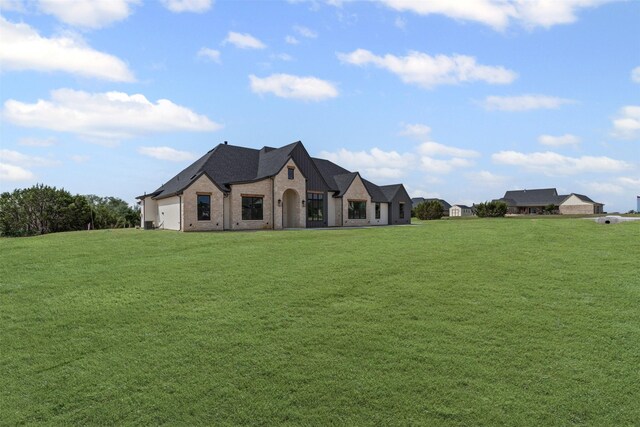 7103 Heathington Ct, Granbury, TX 76049 - french country inspired facade featuring a front lawn and brick siding