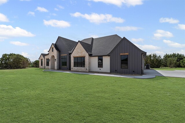 7103 Heathington Ct, Granbury, TX 76049 - view of front of property with a front lawn, board and batten siding, a patio, and central air condition unit