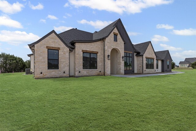 7103 Heathington Ct, Granbury, TX 76049 - french country style house featuring cooling unit, a shingled roof, a front yard, and stone siding