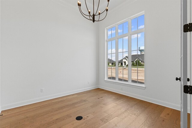 7103 Heathington Ct, Granbury, TX 76049 - unfurnished dining area featuring a chandelier, light wood-style flooring, baseboards, and ornamental molding