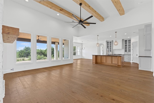 7103 Heathington Ct, Granbury, TX 76049 - unfurnished living room featuring beam ceiling, wood finished floors, a ceiling fan, and recessed lighting