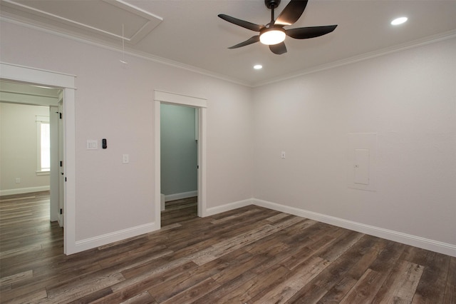 empty room featuring ceiling fan, ornamental molding, baseboards, attic access, and dark wood-style flooring