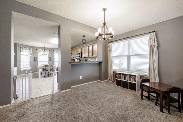 carpeted bedroom featuring a textured ceiling, ceiling fan, and baseboards