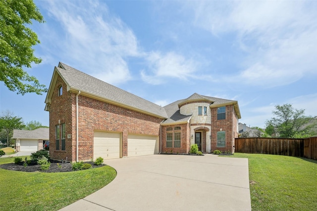 french provincial home featuring fence, driveway, brick siding, and a front yard