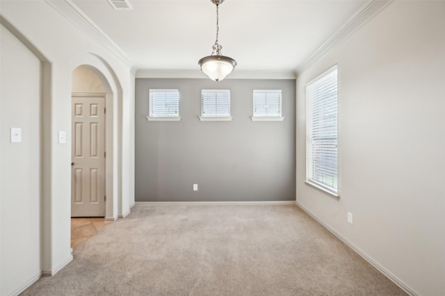 unfurnished room with visible vents, light colored carpet, arched walkways, and ornamental molding