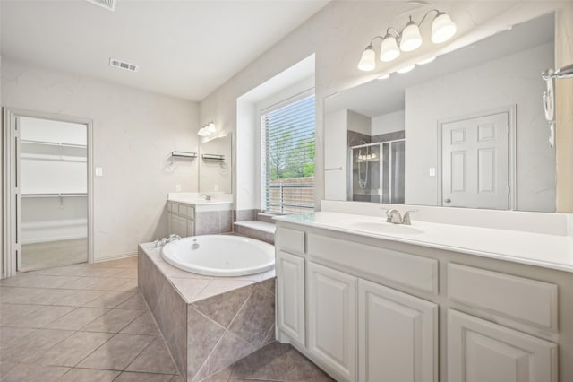 9616 Barksdale Dr, Fort Worth, TX 76244 - bathroom with two vanities, a shower stall, a bath, tile patterned flooring, and a spacious closet
