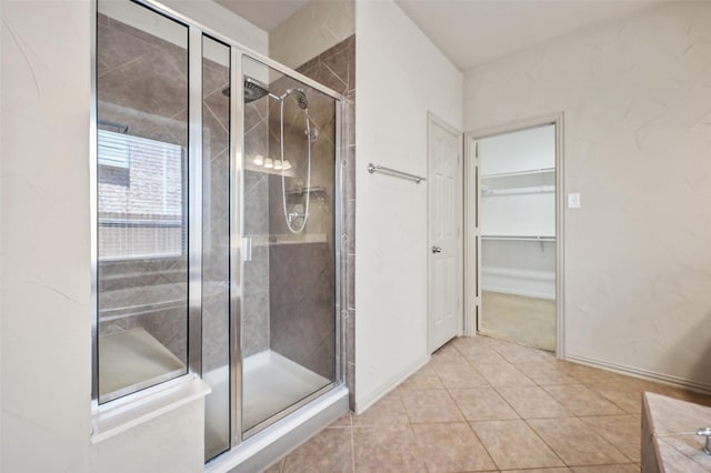 full bathroom featuring baseboards, tile patterned floors, and a stall shower