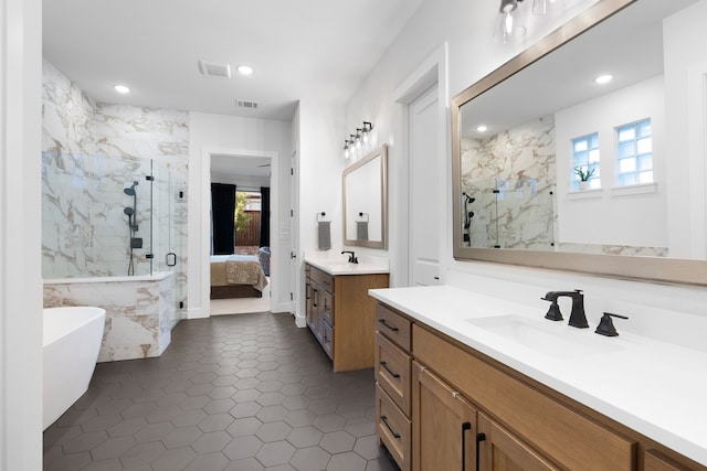 full bath with visible vents, a sink, a marble finish shower, and recessed lighting