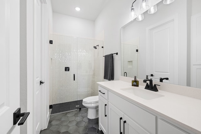 bathroom featuring a shower stall, tile patterned floors, vanity, and toilet