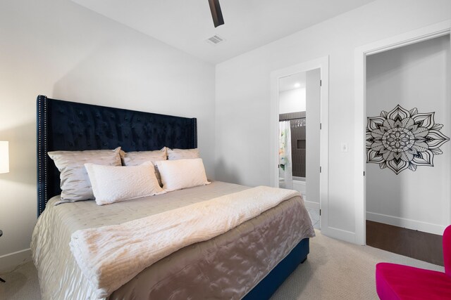 carpeted bedroom with baseboards, a ceiling fan, ensuite bathroom, and visible vents