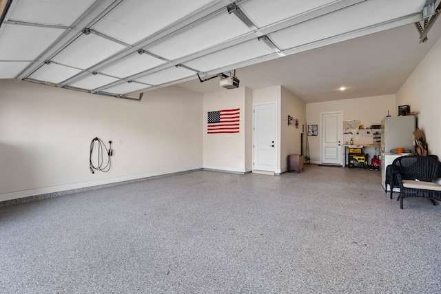 garage featuring a garage door opener and baseboards