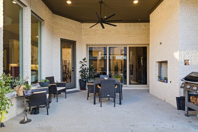 view of patio featuring grilling area, ceiling fan, and outdoor dining space