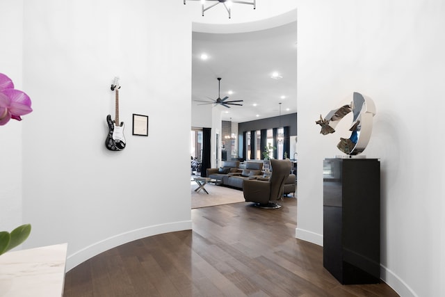 hall featuring baseboards, dark wood-style floors, and recessed lighting