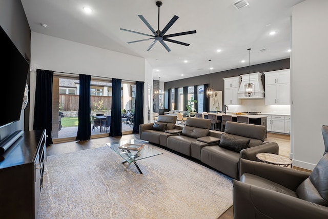 living room with recessed lighting, visible vents, light wood finished floors, and ceiling fan