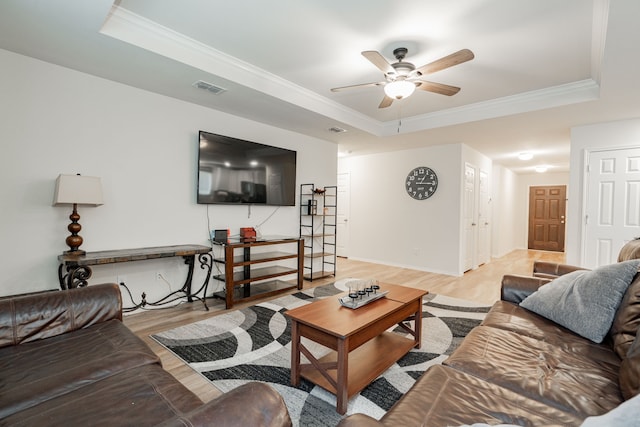1208 Perrin Dr, Forney, TX 75126 - living area with a raised ceiling, ornamental molding, a ceiling fan, light wood-style flooring, and baseboards