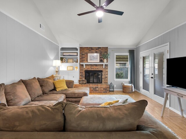 living room featuring visible vents, ceiling fan, a brick fireplace, wood finished floors, and high vaulted ceiling