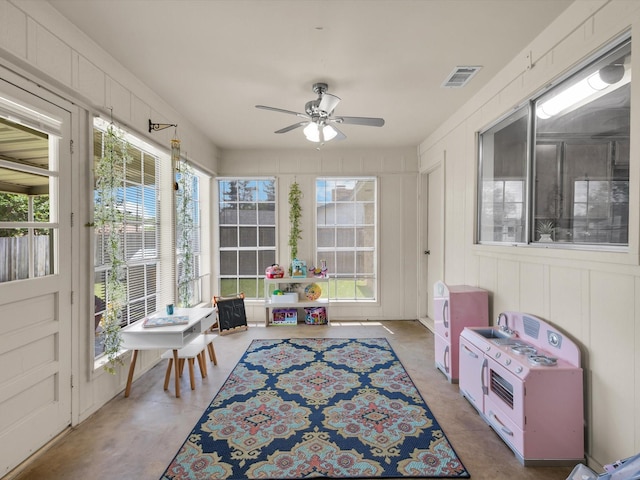 sunroom / solarium with ceiling fan and visible vents