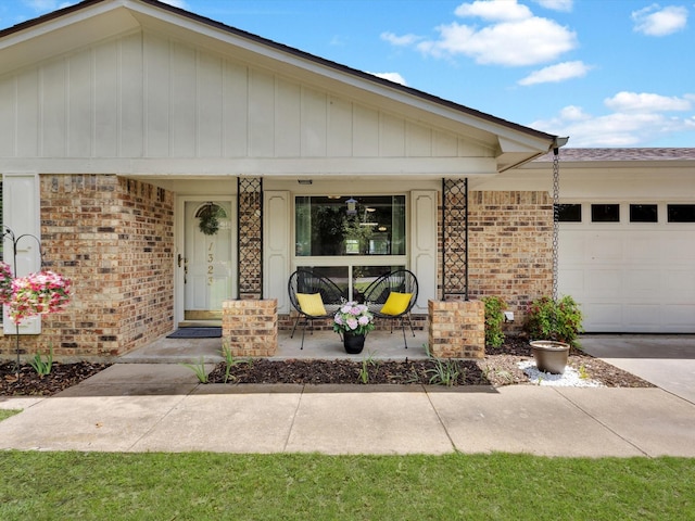 view of front of home featuring a porch, brick siding, and a garage