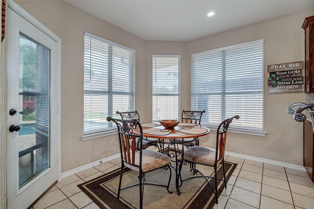 dining room featuring baseboards, recessed lighting, and light tile patterned flooring