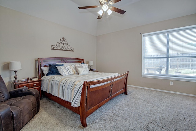 bedroom with ceiling fan, light carpet, vaulted ceiling, and baseboards