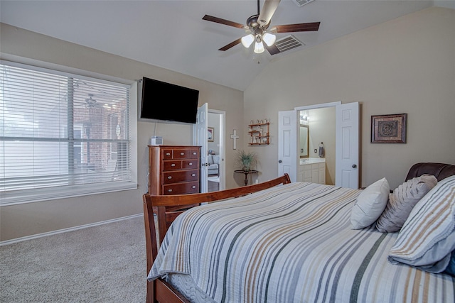 carpeted bedroom with lofted ceiling, visible vents, ensuite bath, baseboards, and ceiling fan