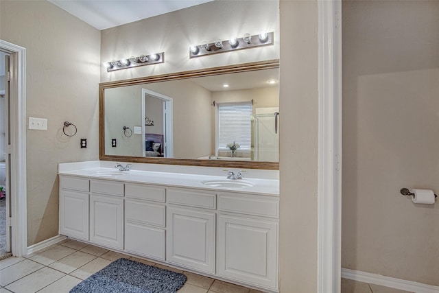 bathroom featuring tile patterned flooring, a sink, and double vanity