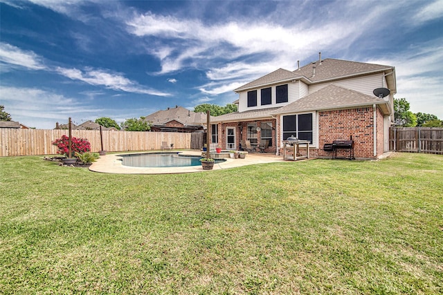rear view of house with a patio area, a shingled roof, a fenced backyard, a yard, and brick siding