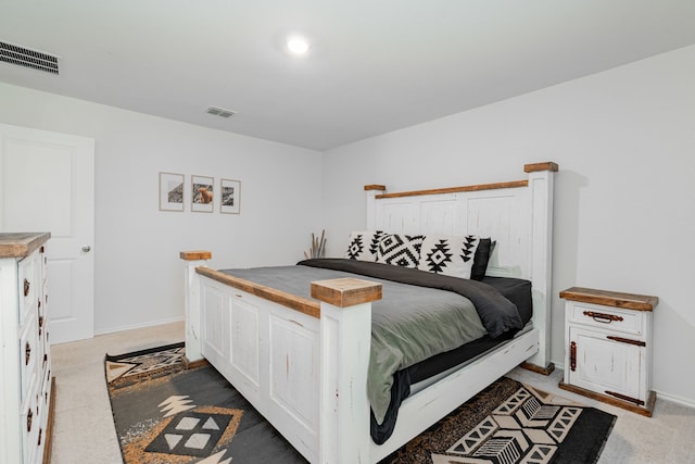 bedroom with light carpet, baseboards, and visible vents