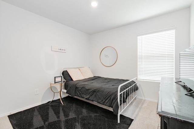 bedroom with carpet floors and baseboards