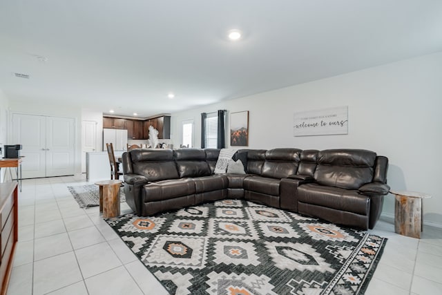 living area with light tile patterned flooring, visible vents, and recessed lighting