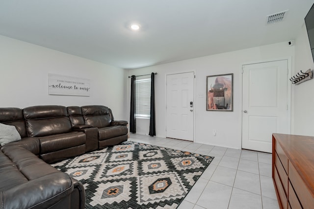 living area featuring visible vents, baseboards, and light tile patterned floors