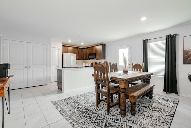 dining area featuring baseboards, recessed lighting, and light tile patterned flooring