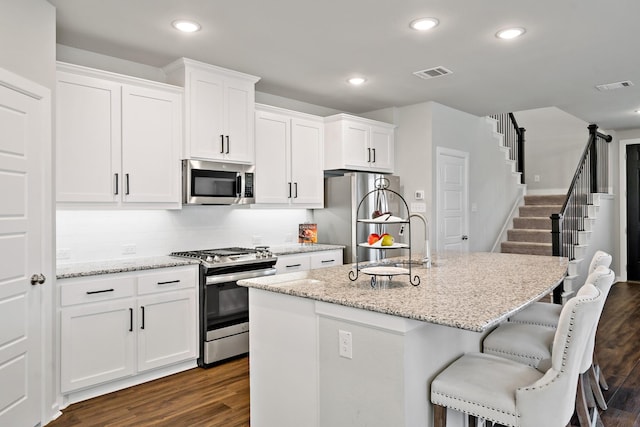 kitchen featuring white cabinets, visible vents, and appliances with stainless steel finishes