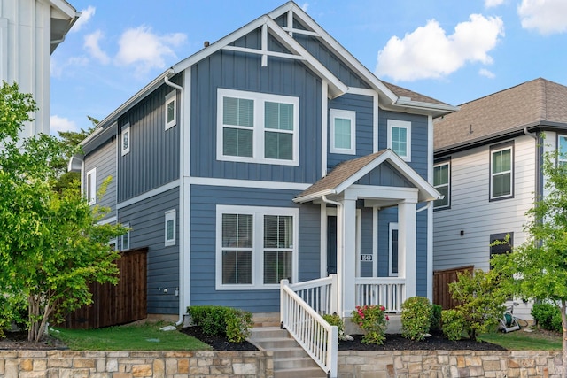 craftsman inspired home featuring board and batten siding and fence