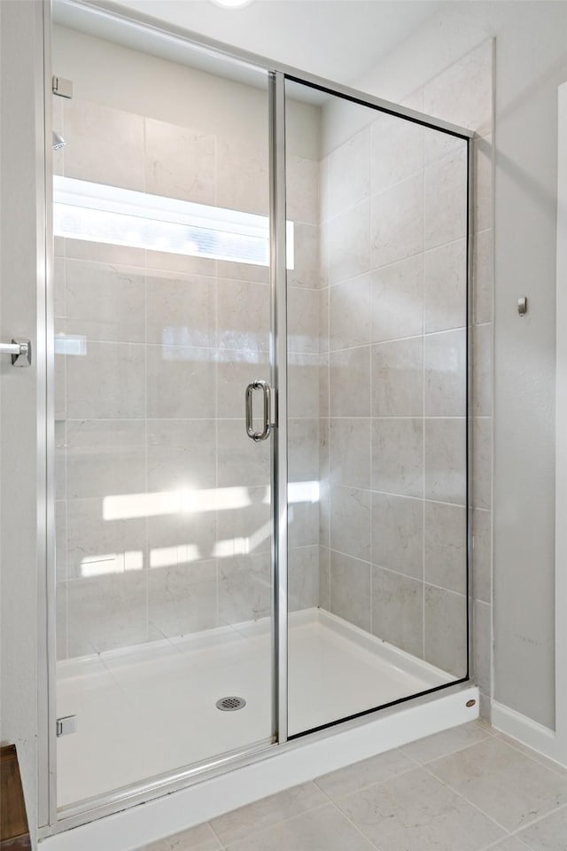 bathroom with tile patterned floors and a stall shower