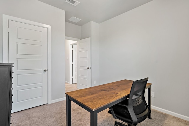office area featuring baseboards, visible vents, and light colored carpet