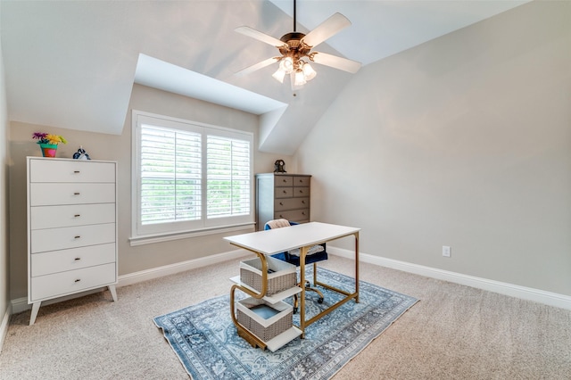 home office with baseboards, lofted ceiling, ceiling fan, and light carpet