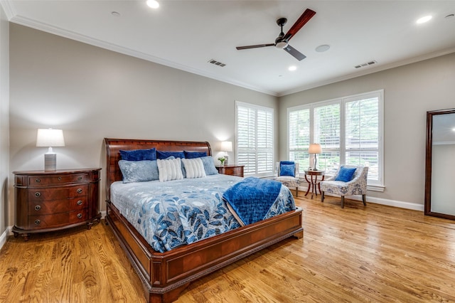 bedroom featuring light wood finished floors, visible vents, and ornamental molding