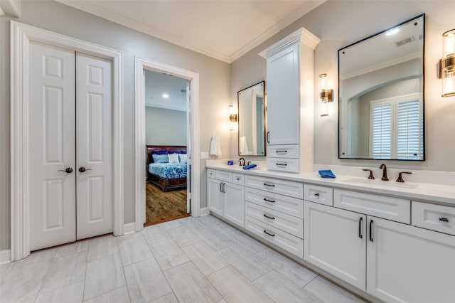 full bathroom featuring a sink, double vanity, ensuite bathroom, visible vents, and ornamental molding