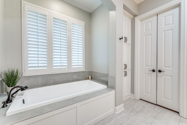 full bath featuring a bath and crown molding