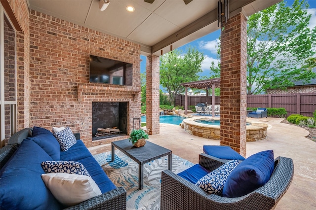 view of patio featuring an outdoor living space with a fireplace, a fenced in pool, a fenced backyard, and an in ground hot tub