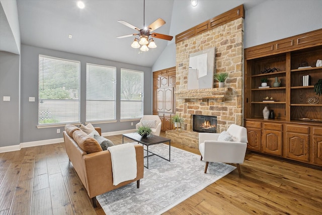 3417 Bear Creek Dr, Hurst, TX 76054 - living area with a ceiling fan, light wood-style flooring, a fireplace, baseboards, and high vaulted ceiling