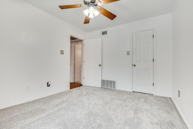 unfurnished bedroom with baseboards, visible vents, and carpet