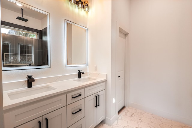 full bathroom with double vanity, tile patterned flooring, and a sink